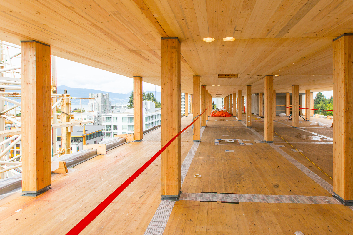 Internal view of Brock Commins Tallwood House, showing mass timber columns, light frame construction, and prefabricated wooden panels.