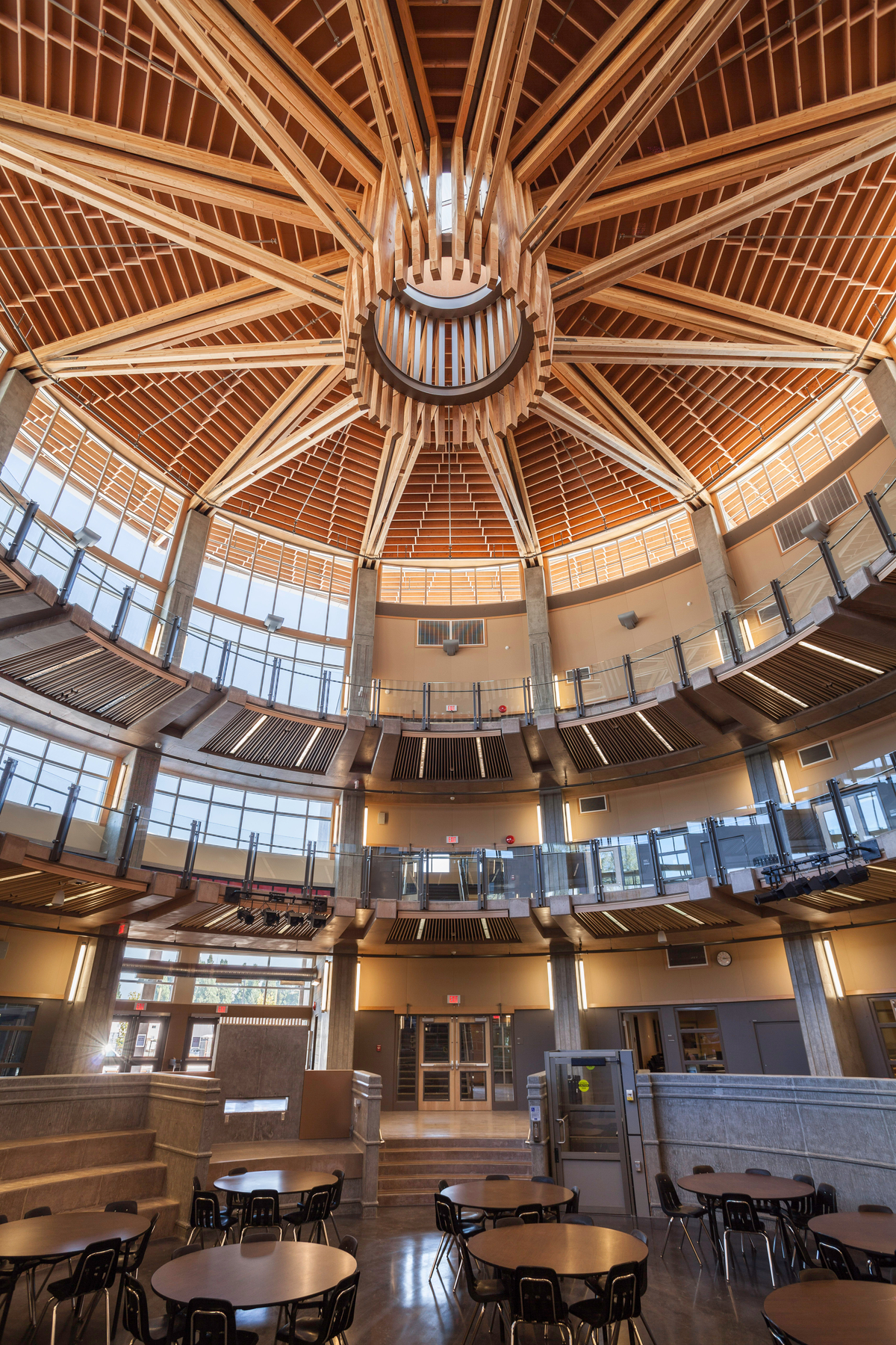 Glue-laminated timber (Glulam), paneling, plywood, and solid-sawn heavy timbers were combined to create the concentric circles and circular balcony shown in this interior image of the Abbotsford Senior Secondary School ceiling