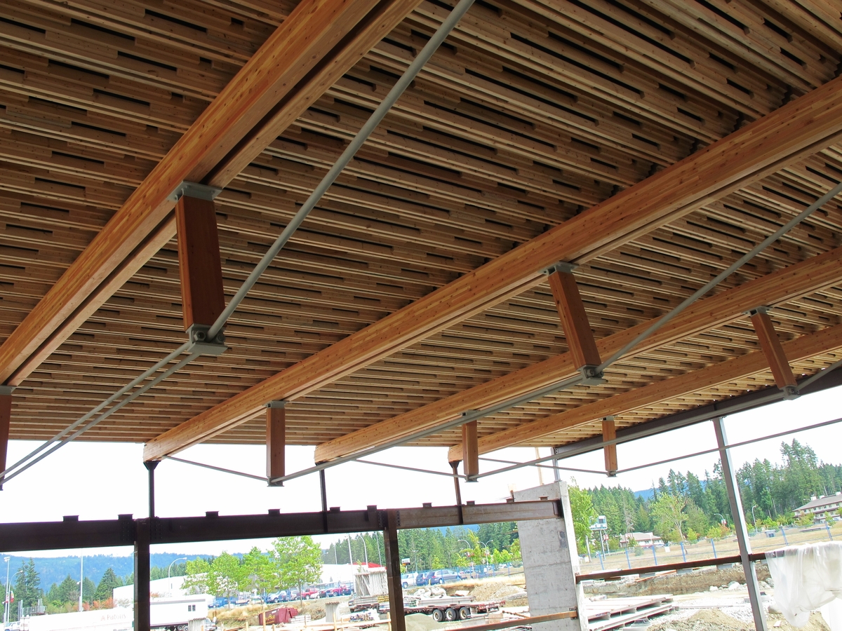 Prefabricated ceiling panels shown installed above supporting glue-laminated (Glulam) beams and columns at Alberni District Secondary School