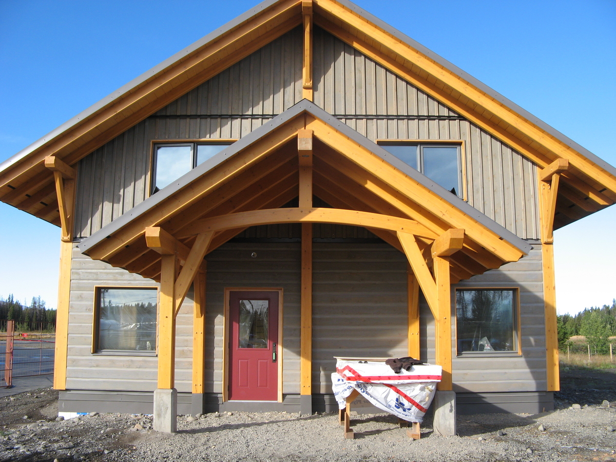 Exterior daytime view of newly completed 90-square-metre Anahim Lake Airport Terminal showing cross-laminated timber (CLT) and glue-laminated timber (Glulam) constructed entrance way and primary roof
