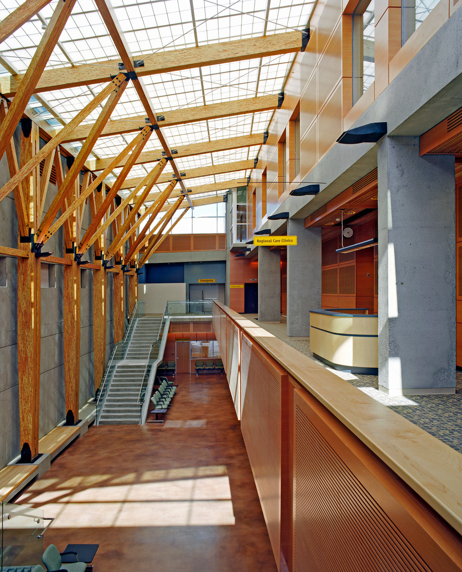 Interior of a hospital hallway showing wood beams, public seating and wood millwork