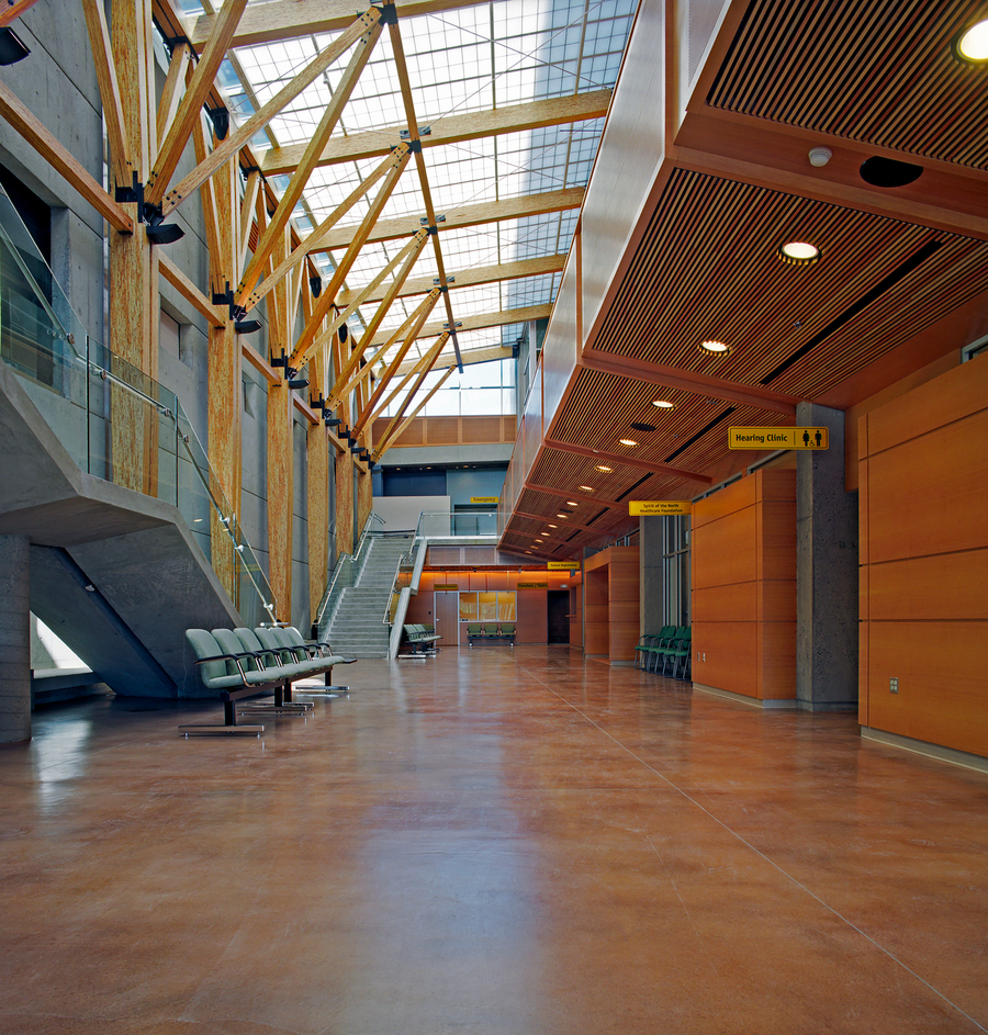 Interior of a hospital hallway showing wood beams, public seating and wood millwork