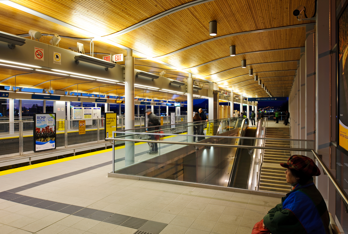 Lansdowne Canada Line Station interior with people waiting for train at dusk
