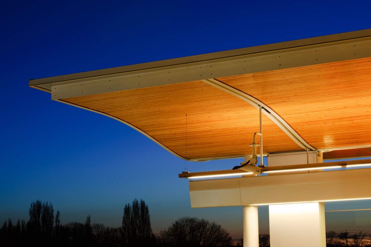 Lansdowne Canada Line Station, wood detailed roof pictured framed by blue sky at dusk