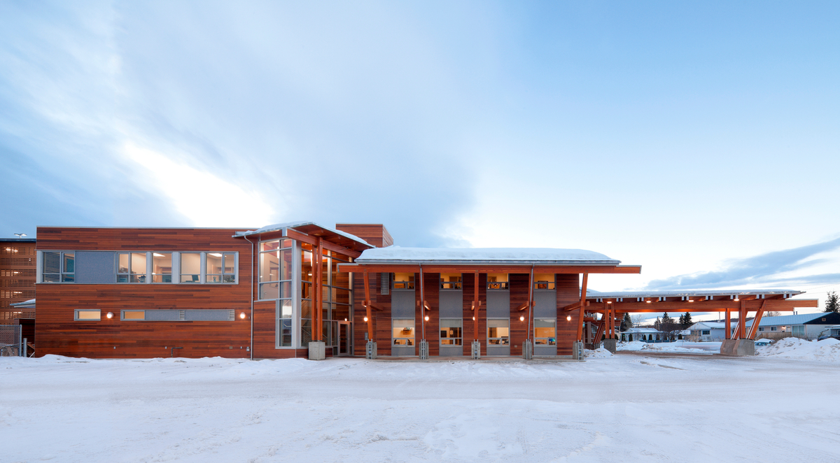 Exterior daytime winter view of low rise two story Canadian Cancer Society Kordyban Lodge, showing Glue-laminated timber (Glulam), and decorative siding