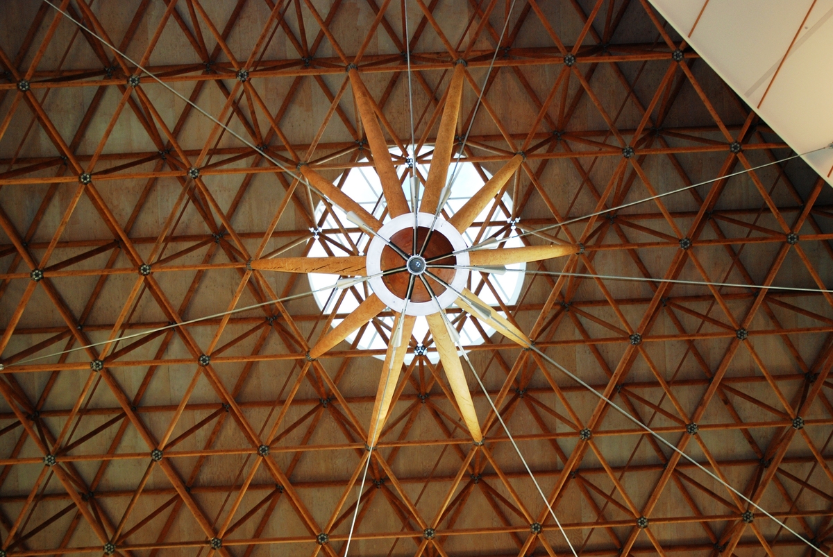 Interior daytime view of Surrey Central City atrium roof showing a geometric wood space frame constructed from 3,700 Douglas-fir peeler cores—making full use of a by-product of the plywood industry