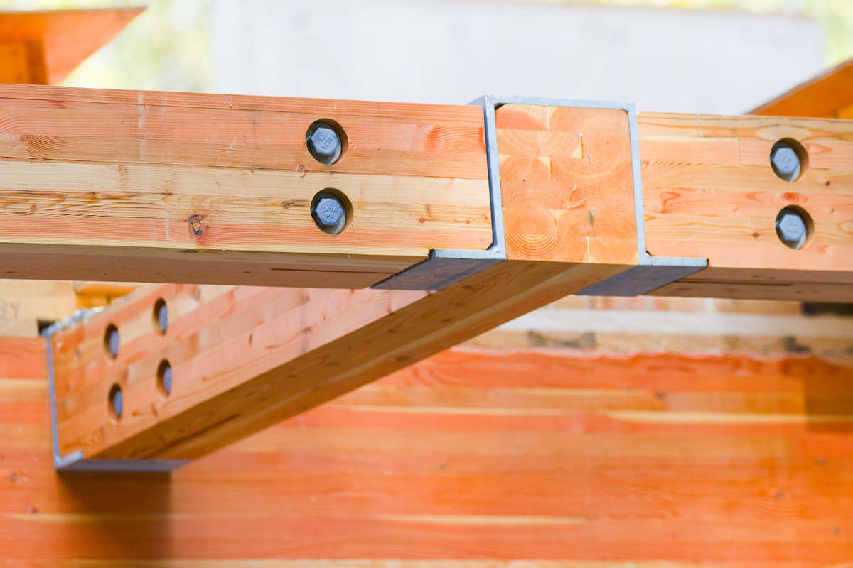 Close up image of glue-laminated timber (glulam) and steel structural connection within Cheakamus Centre Blueshore Environmental Learning Centre