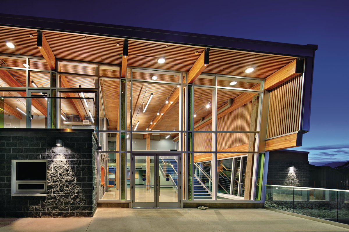 Exterior view of Cowichan Lake Sports Arena showing the heavy timber construction, glue-laminated timber (glulam) beams, solid-wood decking and western red cedar cladding