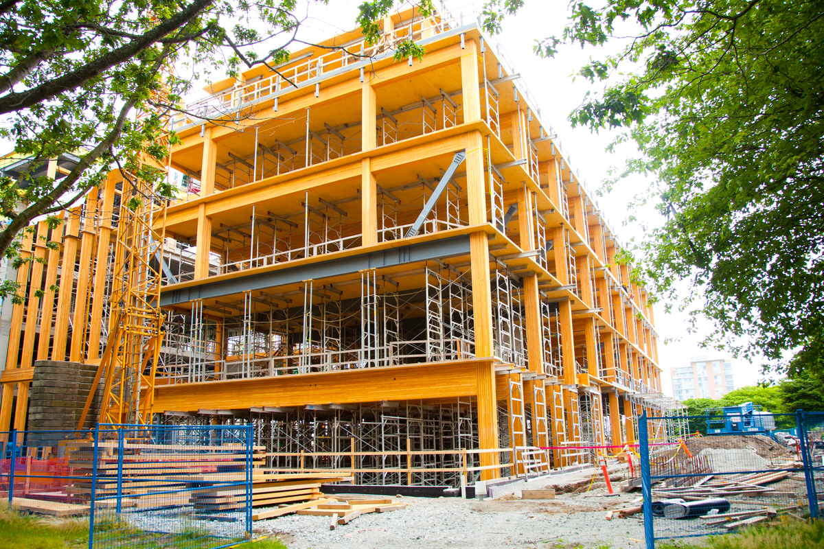 Exterior daytime mid construction view of five storey Earth Sciences Building showing full-storey steel glulam hybrid transfer trusses, cross-laminated timber (CLT), glue-laminated timber (glulam) and laminated strand lumber (LSL)