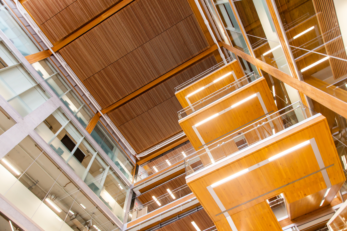 Interior upward view inside UBC Earth Sciences Building showing the floating cantilevered solid timber stair design that demonstrates the architecture that can be achieved with mass timber