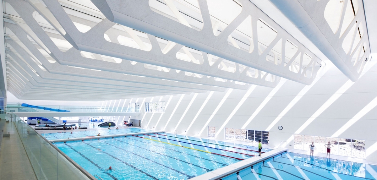 White stained glue-laminated timber (Glulam), Laminated strand lumber (LSL), and Plywood are prominently featured in this interior view of the Guildford Aquatic Centre