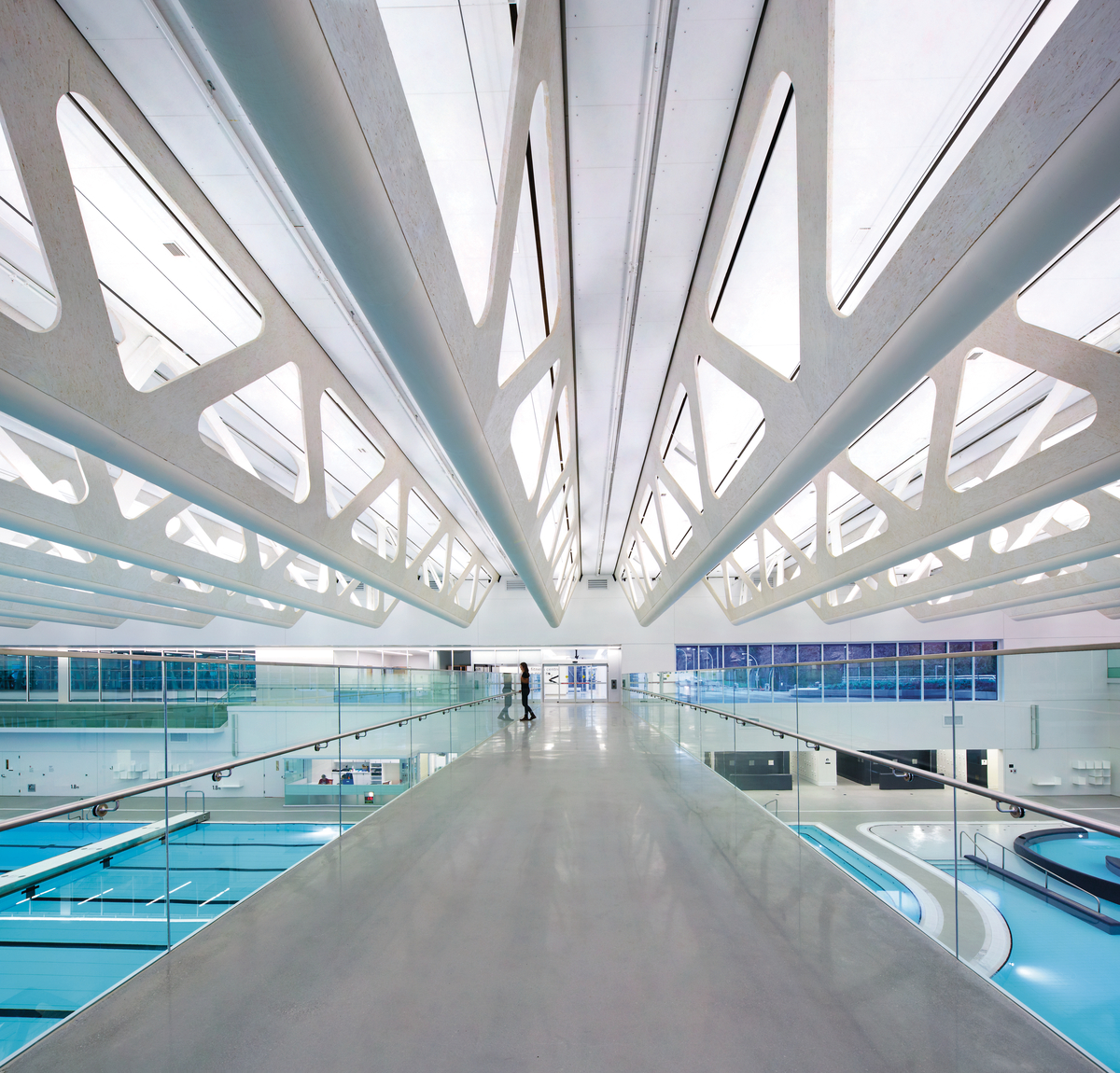 White stained Glue-laminated timber (Glulam), Laminated strand lumber (LSL), and Plywood are prominently featured in this interior view of the Guildford Aquatic Centre