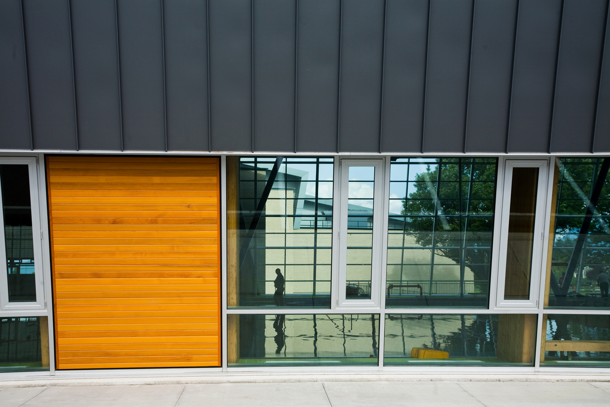 Exterior daytime image of low rise Hillcrest Centre showing close up of glass and wood exterior