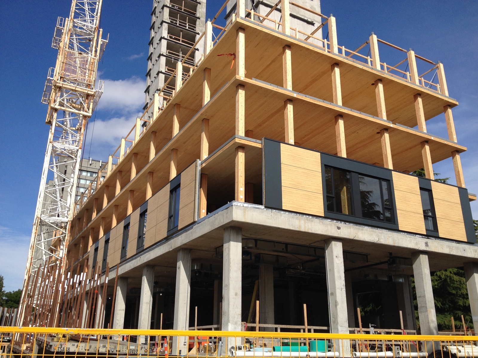 Prefabricated Wood Hybrid Panels shown partially installed in this daytime upward exterior photo of the mid construction Brock Commons Tallwood House