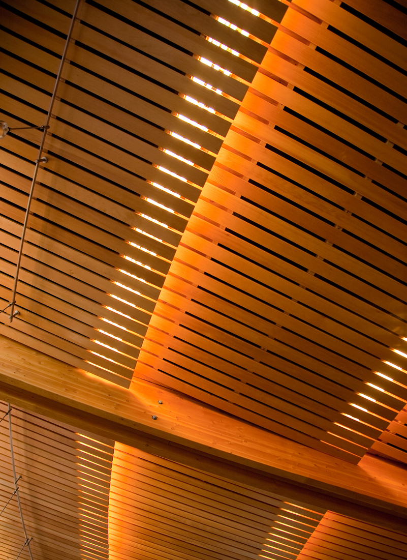 Interior close up view of Four Hosts First Nations Pavilion showing decorative roof slats and structural glue-laminated timber (glulam) beams