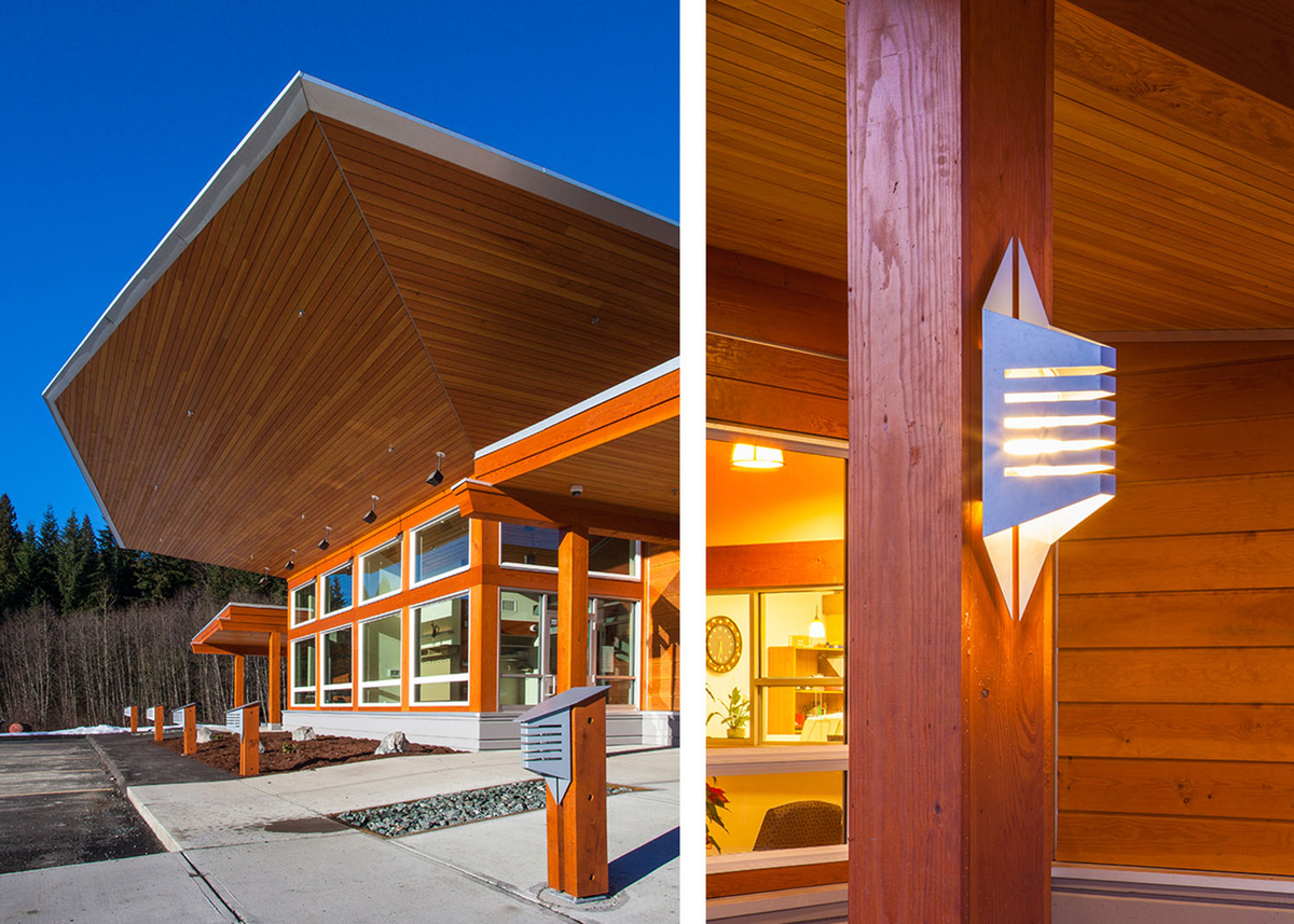 Exterior afternoon view of low rise Kitsumkalum Health Centre, showing extensive use of wood components, including paneling, plywood, siding, and solid-sawn heavy timber in both Douglas-fir and western red cedar