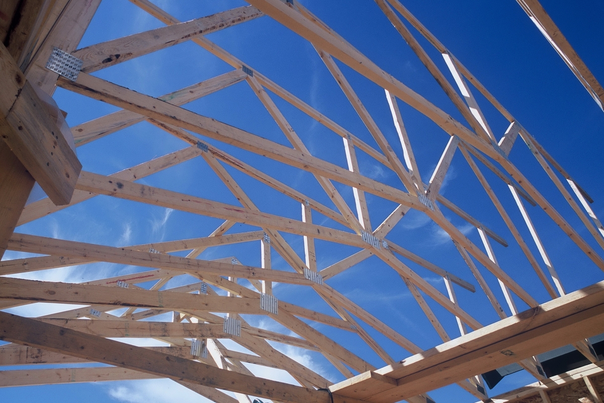 Roof trusses, a close up being shown here in a daytime sunny image, are an example of light-frame wood construction