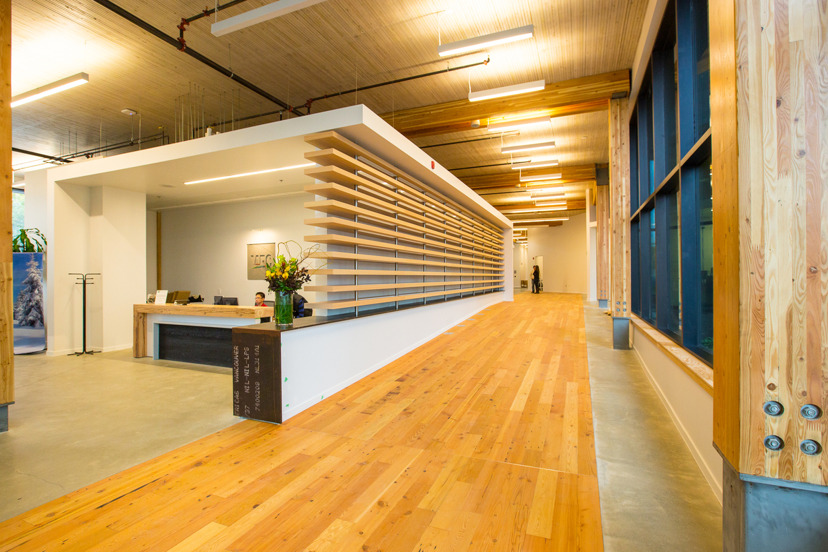 Interior view of completed MEC Headquarters building reception area featuring mass timber construction, Glue-laminated timber (Glulam), Nail-laminated timber (NLT), and abundant millwork