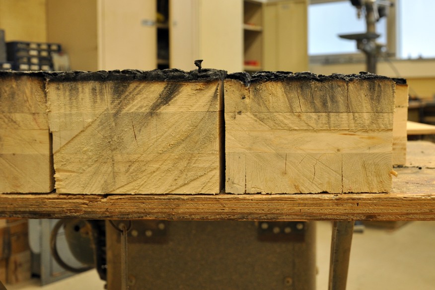 Close up of mass timber sections with exterior char after successful fire performance testing