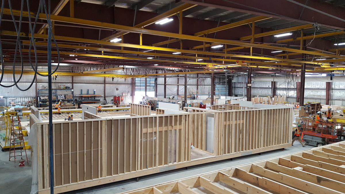 Interior occupied view of Metric Modular Factory Prefabrication facility during construction of prefabricated living unit and used as example of prefabricated wood building systems