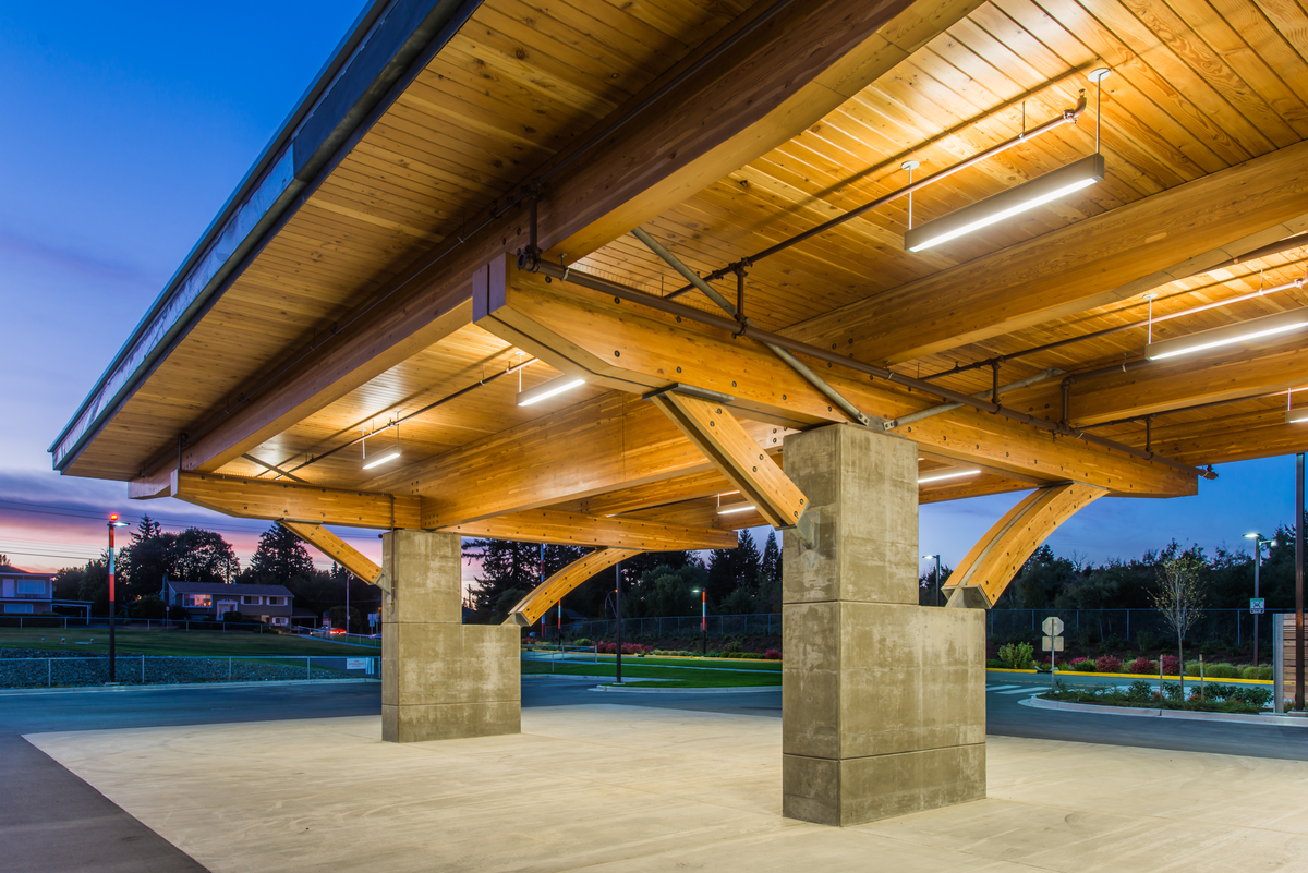 Exterior evening view of Nanaimo Regional General Hospital Emergency Department entrance showing hybrid mass timber canopy, constructed of concrete support posts, Glue-laminated timber (Glulam) beams and heavy timber canopy elements