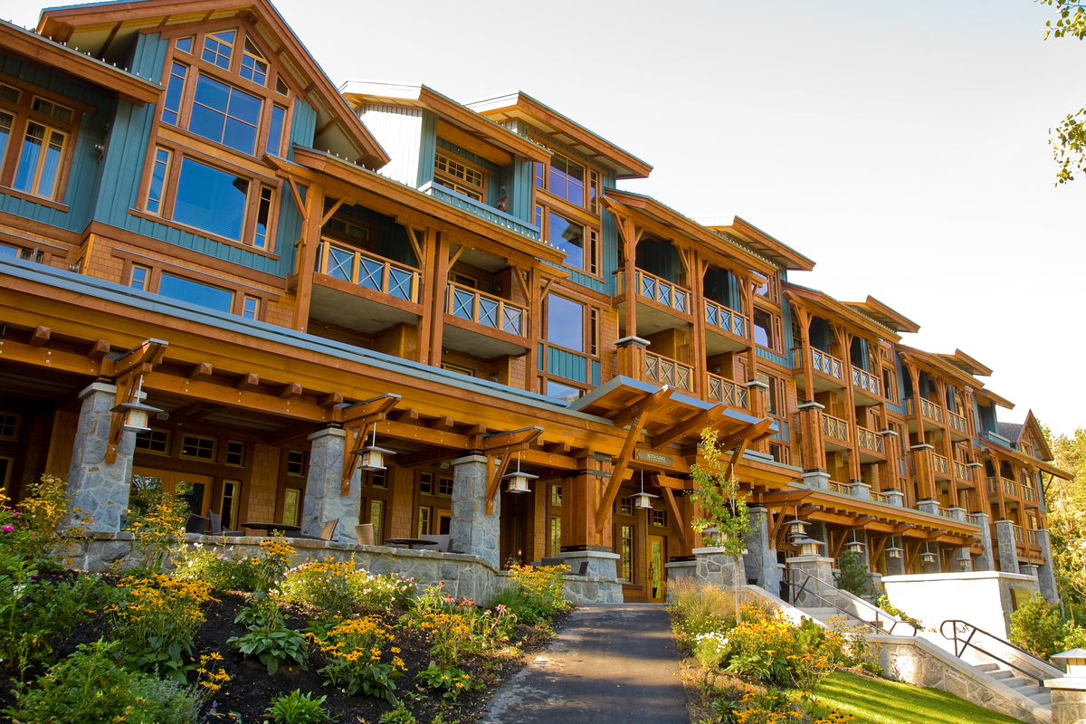 Exterior daytime upward profile view of Nita Lake Lodge, showing extensive use of wood, including millwork, plywood, solid-sawn heavy timber, Post + beam