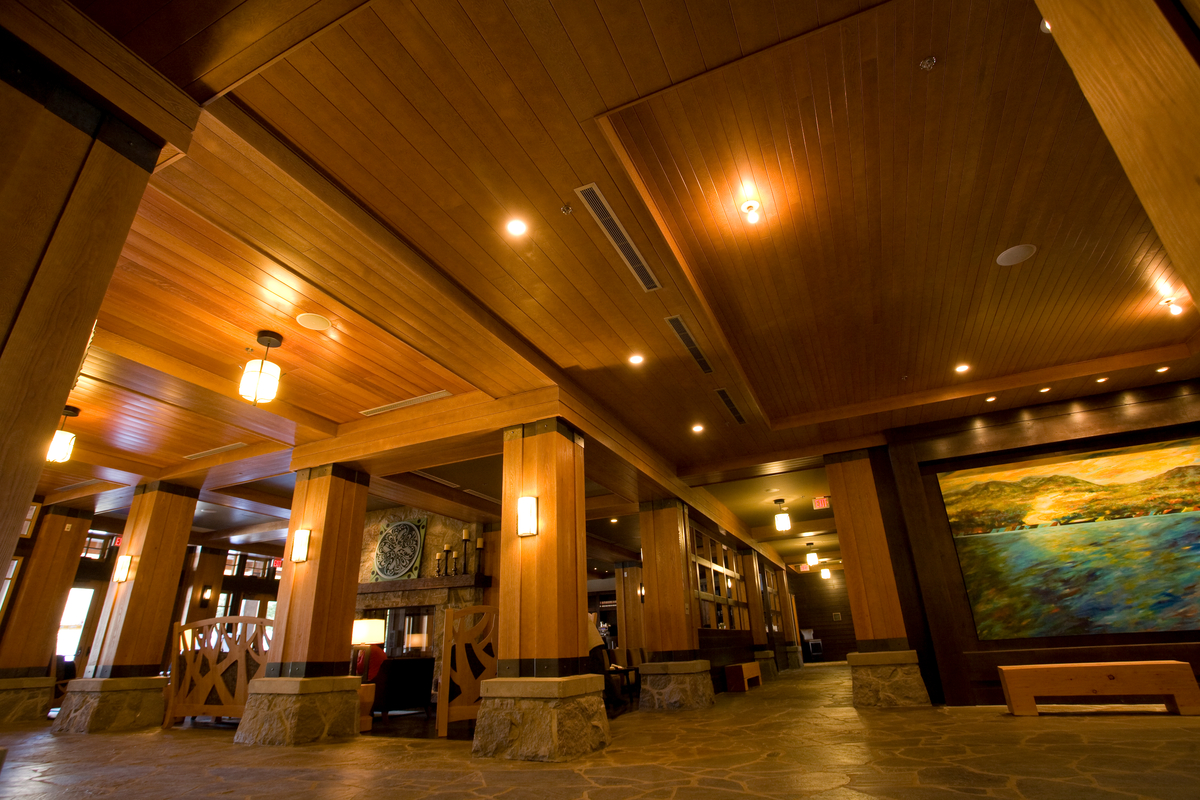 Interior daytime main entrance view of Nita Lake Lodge, showing walls and ceilings almost entirely of wood, including Millwork, Plywood, solid-sawn heavy timber, Post + beam