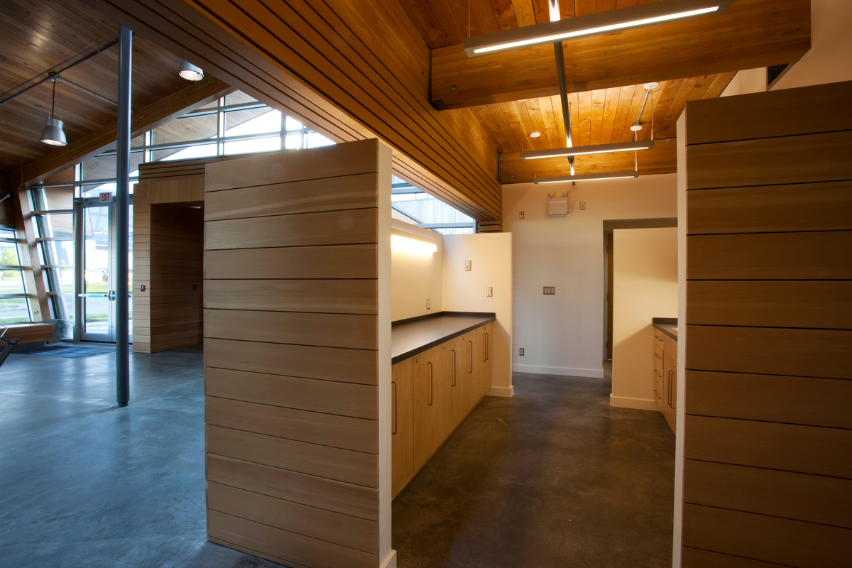 Interior daytime view of newly completed Northern Lights College Energy House showing Douglas-fir and western red cedar glue-laminated timber (glulam) mass timber, millwork, and exterior paneling