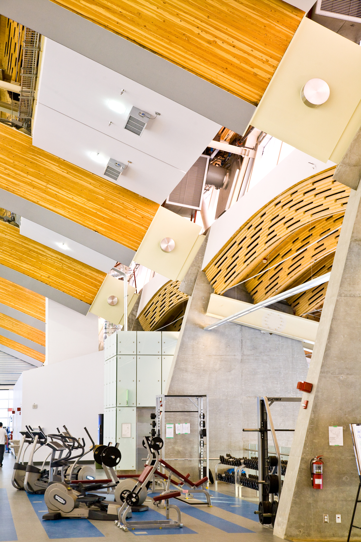 Interior daytime image of glue-laminated timber (Glulam), solid-sawn heavy timbers, and wooden accents as featured in this vibrant interior view of the 33,750 square meter Richmond Olympic Oval