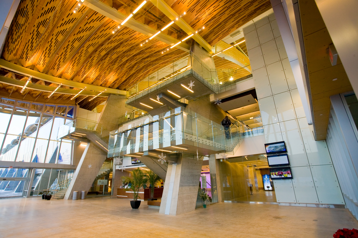 Interior daytime image of glue-laminated timber (Glulam), and wooden roof accents as featured in this interior main entry view of the Richmond Olympic Oval complex