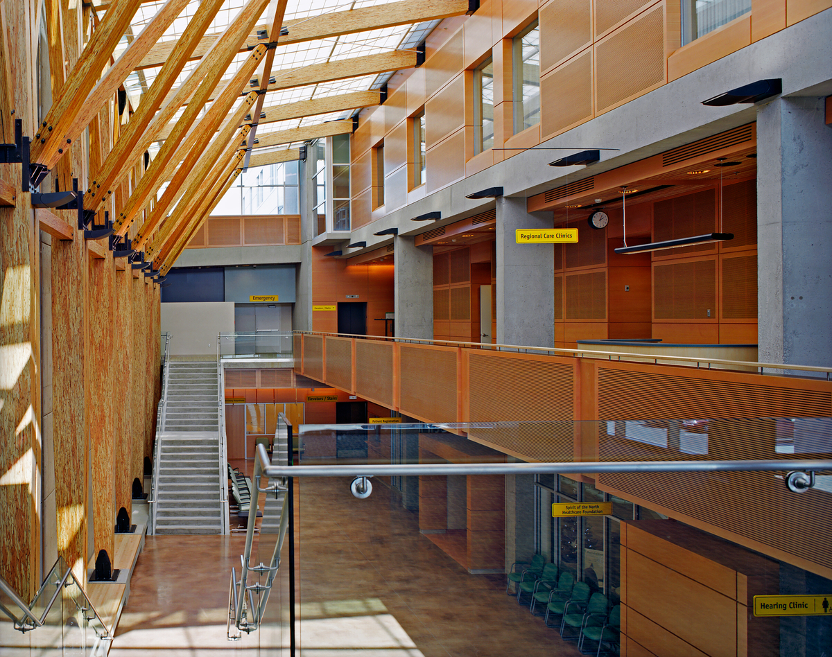 Interior atrium view of three storey University Hospital of Northern BC featuring structural Glue-laminated timber (Glulam) and parallel strand lumber (PSL) in addition to decorative wood siding and paneling