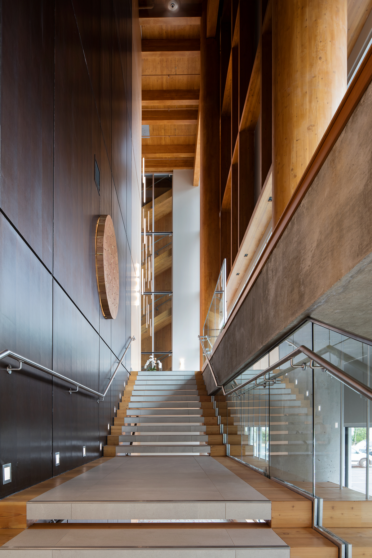 Interior main stairwell view of The West Wing, Penticton Lakeside Resort and Conference Centre highlighting wood timber stairs, and extensive use of exposed glue-laminated timber (glulam) and cross-laminated timber (CLT)