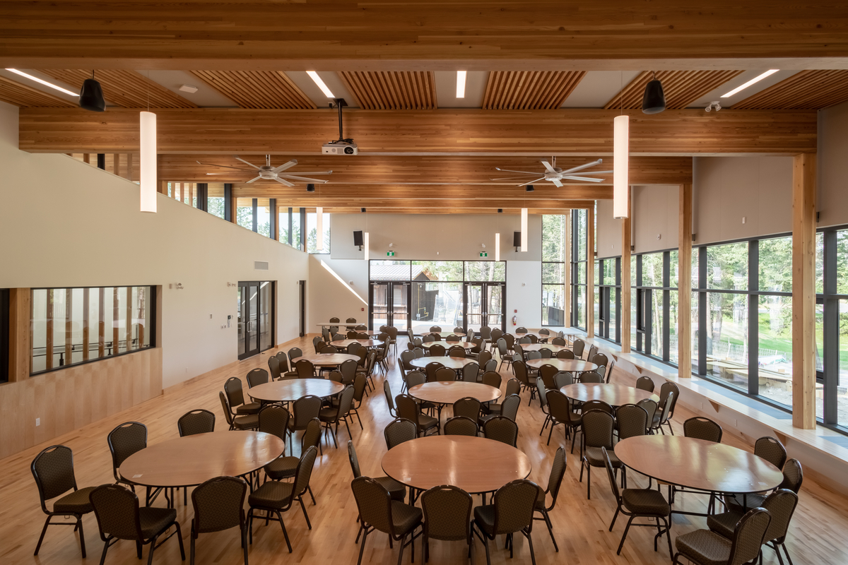 Interior daytime view of Radium Hot Springs Community Hall and Library showing glue-laminated (glulam) timber bean supporting dowel laminated timber (DLT) roofing sections