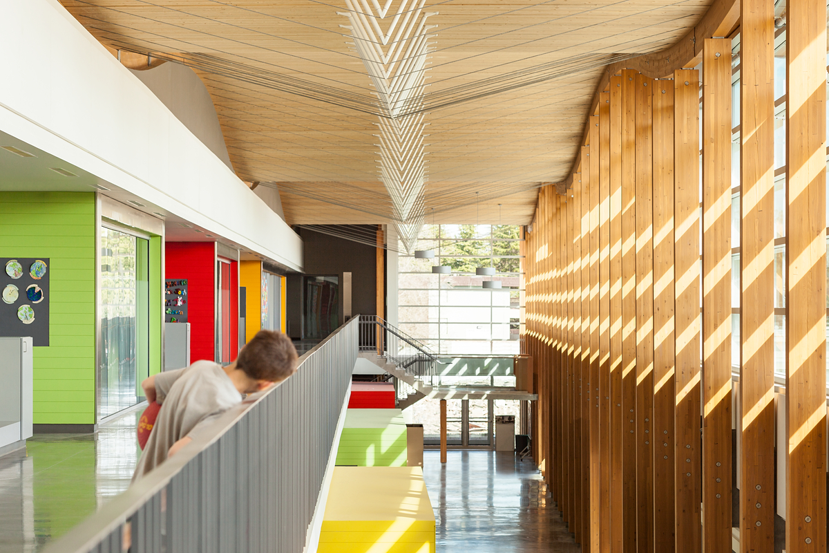 Interior view of Samuel Brighouse Elementary showing student and demonstrating mass timber products, and hybrid timber systems construction