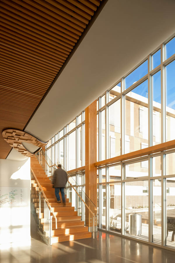 Sechelt Hospital interior with blurred person walking up wooden staircase
