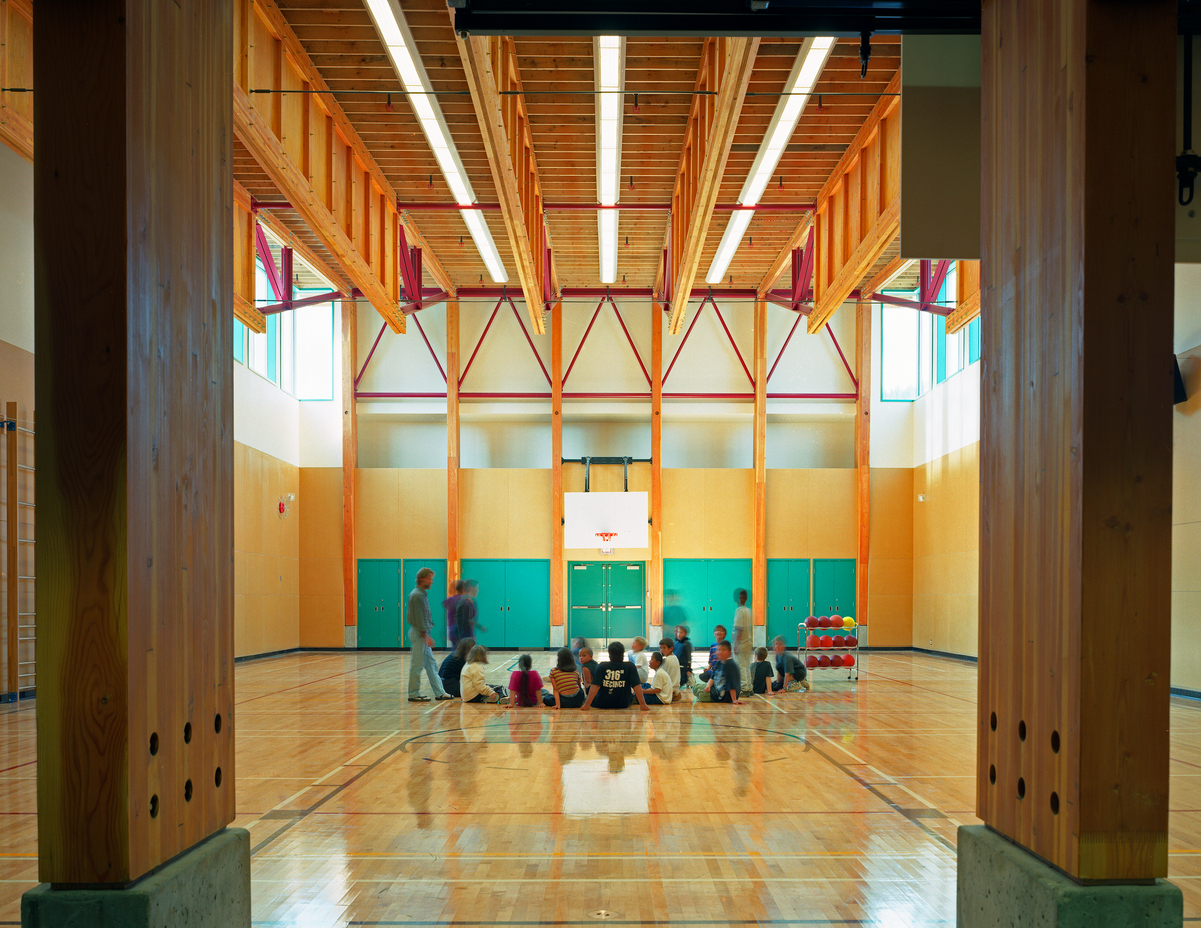 Glue-laminated timber (Glulam) columns support the prefabricated wood frame ceiling in this interior view of the Skidegate Elementary School Gymnasium