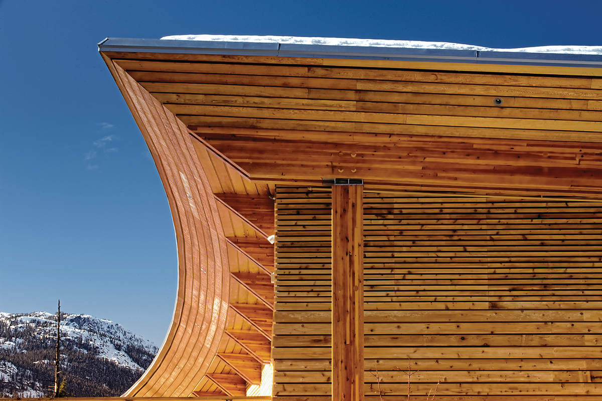 Exterior snowy daytime close up view of Squamish Lilwat Cultural Centre roof overhang showing glue-laminated timber (glulam), millwork, and paneling