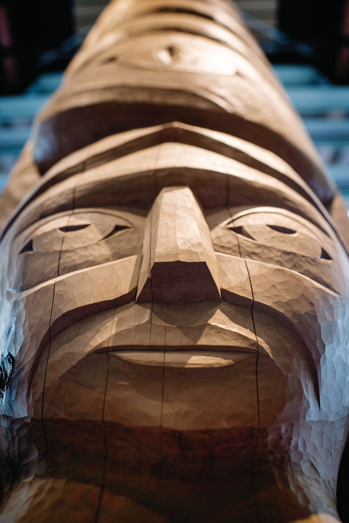 Interior daytime view of Squamish Lilwat Cultural Centre showing close up of intricately carved First Nations totem pole
