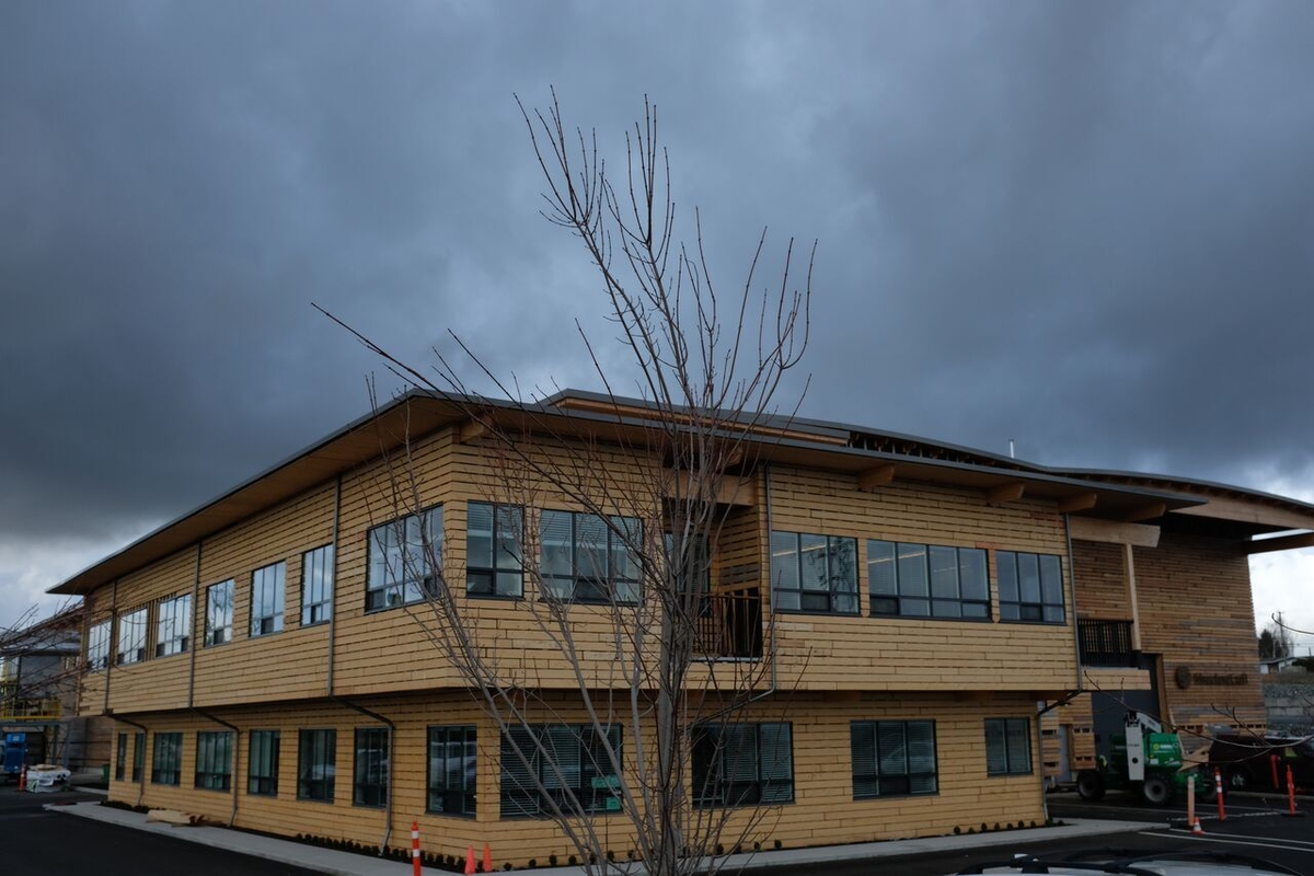 Exterior late afternoon view of StructureCraft Manufacturing Facility showing complete building clad in mass timber panelized prefabricated wood with post & beam accents