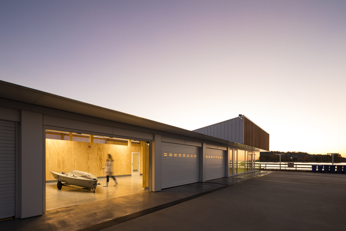 Later afternoon exterior image of the Dock Building at the Royal Vancouver Yacht Club which combines glue-laminated timber (glulam), dimension lumber and plywood, creating a functional storage and workshop facility