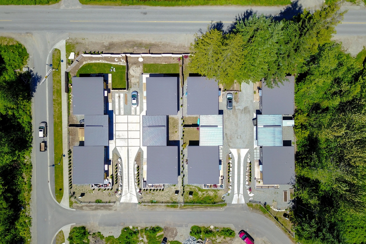 Daytime aerial drone view of four duplexes which were constructed from all-wood modules to quickly deliver affordable housing as part of The Gardens project