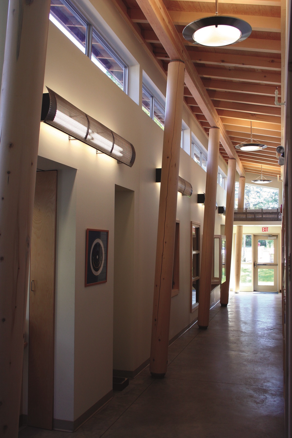 solid-sawn heavy timber pole columns, beams, and roof trusses topped with plywood sheathing are shown in this interior hallway view of the Takamine Community Health Services building