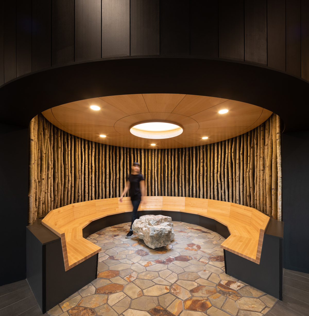 Interior view of Ts’kw’aylaxw Cultural and Community Health Centre circular social area showing comprised of Douglas-fir glue-laminated timber (glulam) columns and prefabricated light wood frame panels