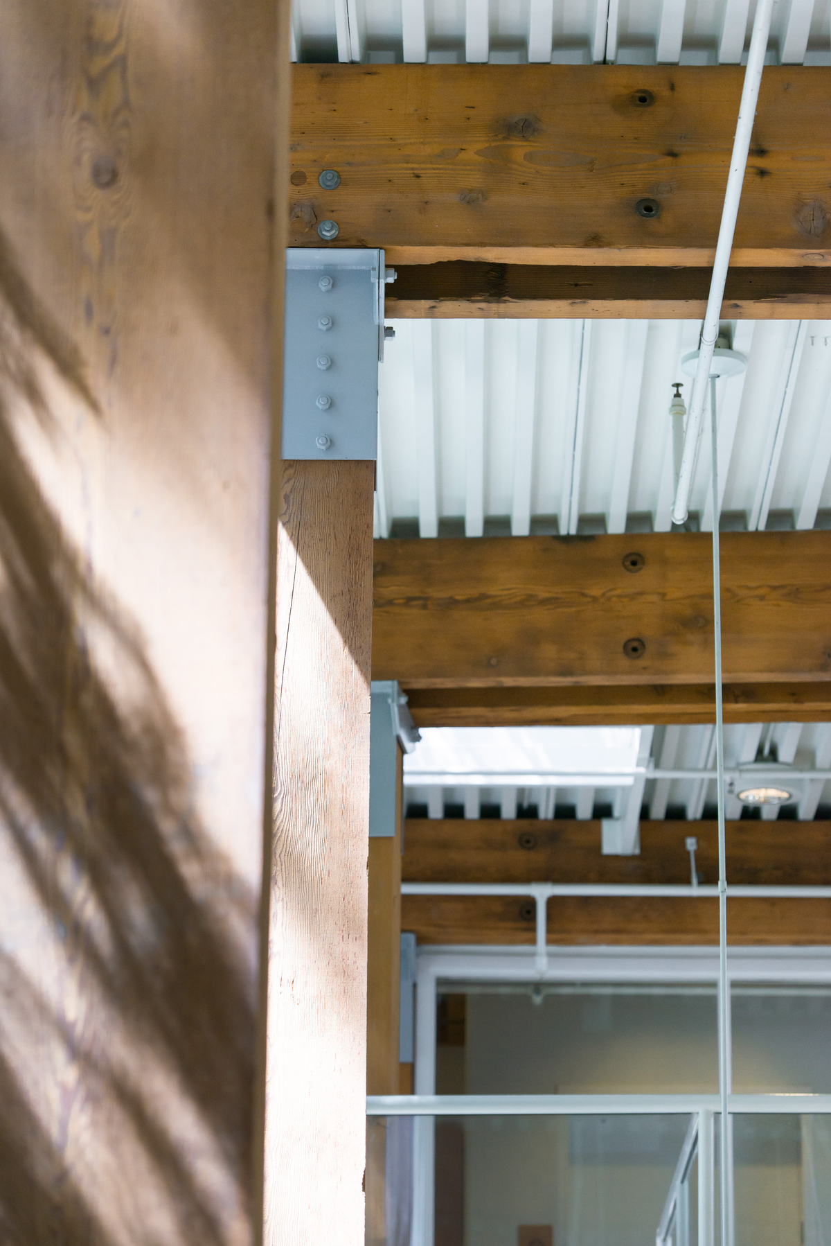 solid-sawn heavy timber beams and columns, with associated metal mating plates, and shown in this close up image at the UBC CK Choi Building