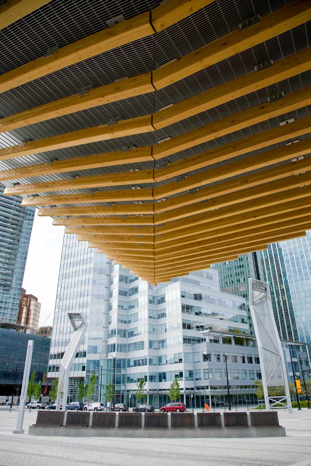 glue-laminated timber (Glulam) ceiling beams are clamped to a metal gridwork in this daytime closeup exterior image at the Vancouver Convention Centre West Building