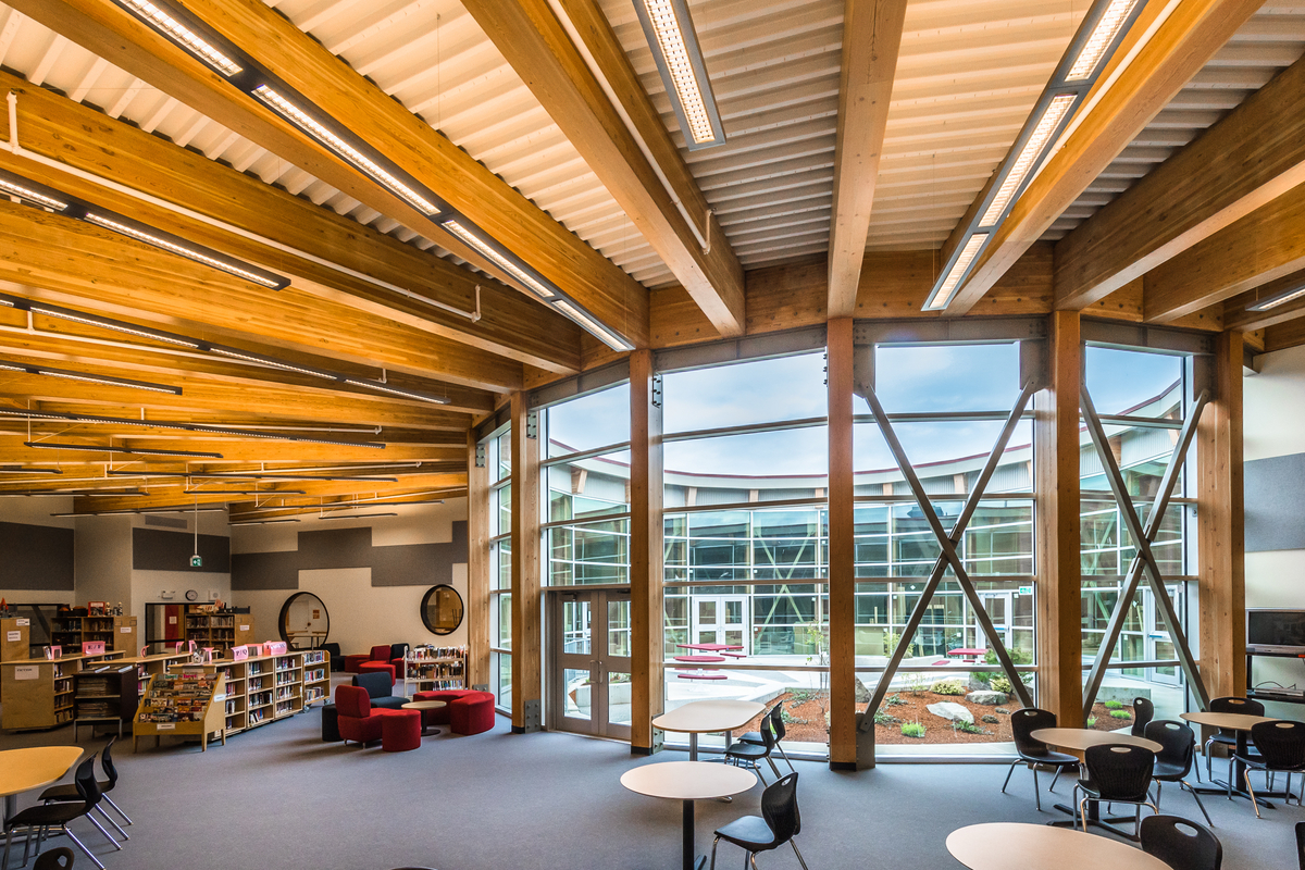 Internal daytime view of low rise Wellington Secondary School showing central circular open air atrium and Glue-laminated timber (Glulam) 'spokes' radiating outward