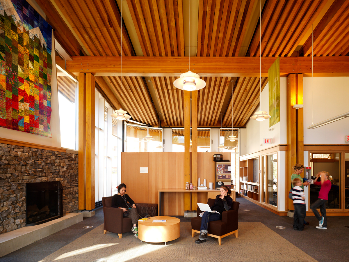 Interior view of Whistler Public Library showing reclaimed Douglas fir millwork and featuring timber post & beam, passive house / high efficiency, and wooden prefabrication construction techniques