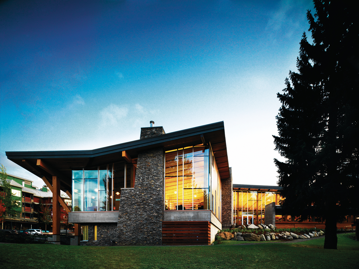 Exterior evening view of Whistler Public Library showing glue-laminated timber (Glulam), Millwork, and Siding; all milled from reclaimed Douglas fir