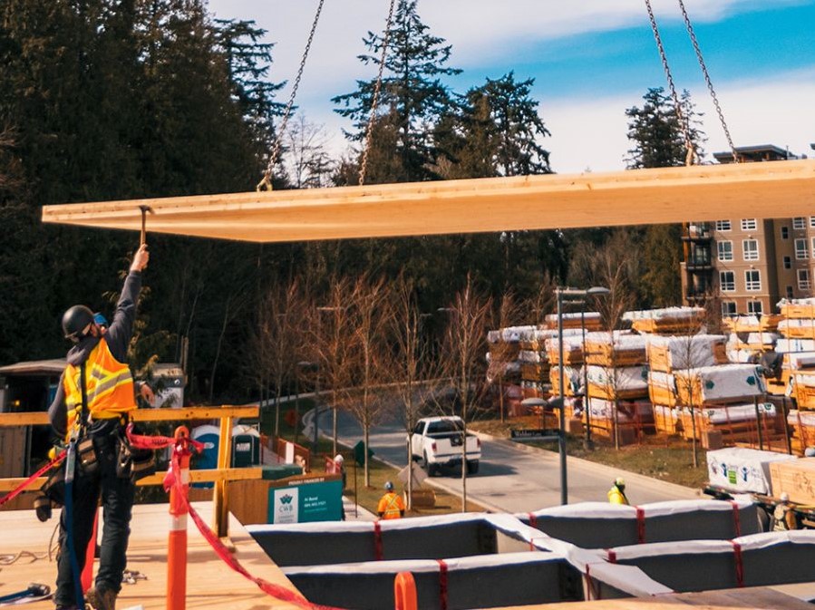 mass timber panel being lowered onto a construction site