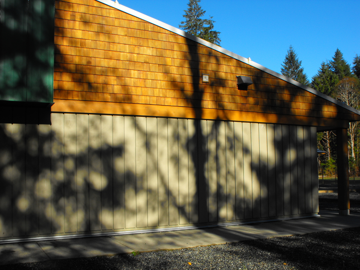 External daytime image of Zeballos Elementary/Secondary School showing wooden siding and wood siding shingles